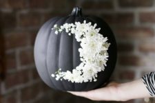 06 go for creative art decorating your matte black pumpkin with white blooms like that