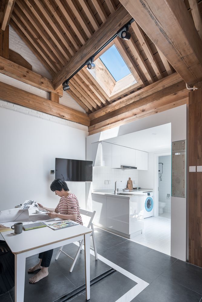 The kitchen flows into a dining space, which is lit up with a large skylight