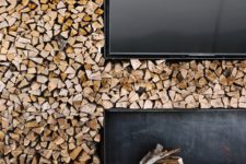 There’s a whole firewood wall with a TV and a niche for a rustic feel