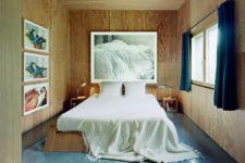 09 The master bedroom is all clad with plywood, and the furniture is made of it, too, a series of artworks and a cool view make it special