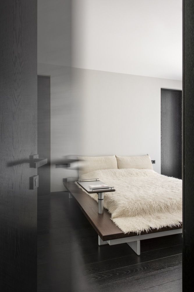 The master bedroom is done with a large platform bed with additional shelves attached