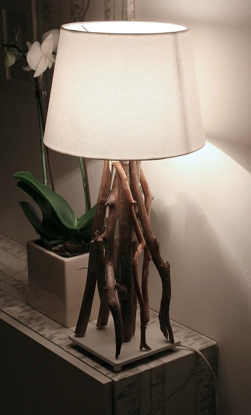 a modern branch lamp of several branches, a porcelain base and a light fabric lampshade