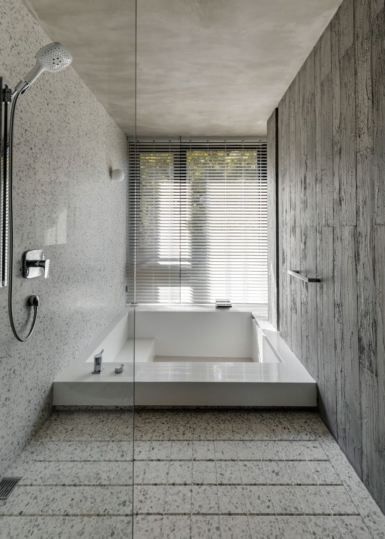 minimalist bathroom design with a sunken bathtub The master bathroom is done with stone and there's a large sunken bathtub