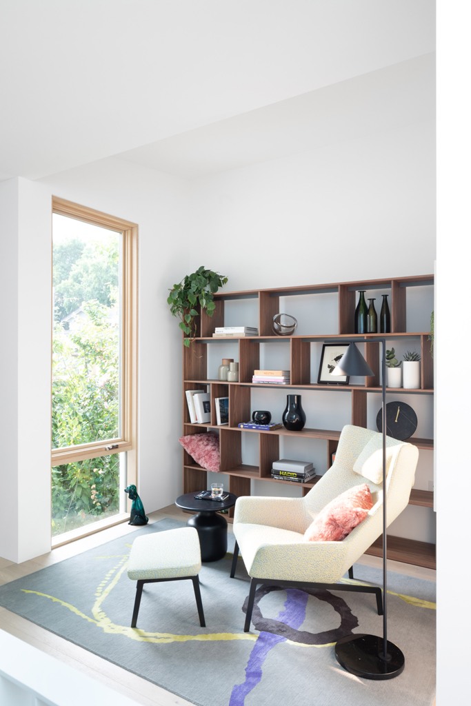 large storage unit in a reading room Comfy furniture is everywhere, here's a reading nook with a chair and a footrest plus a large storage unit