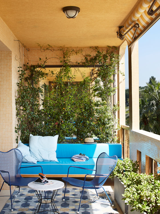 breakfast nook on a balcony This is another side of the balcony, which is a comfy breakfast nook with a bright sofa
