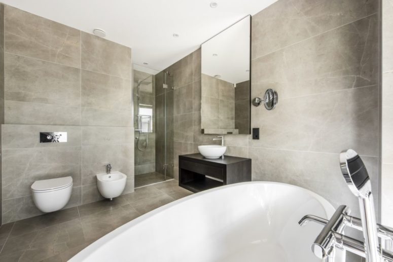 The master bathroom is spacious but looks and feels very welcoming thanks to the wall and floor tiles