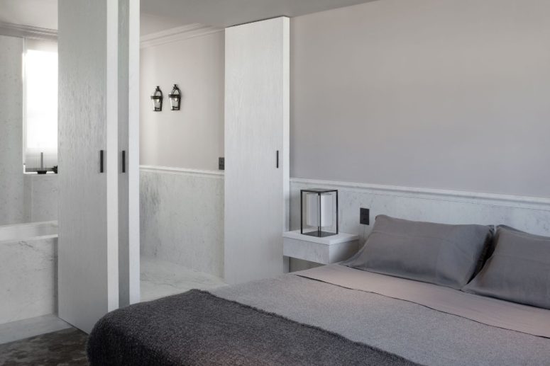 The master bedroom is done in white and shades of grey, greys are dominant to make it more peaceful