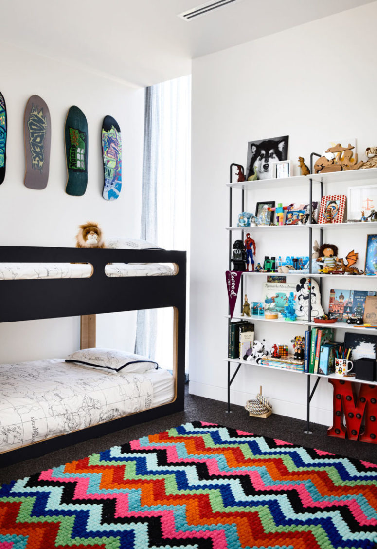 The second room is done with bright colors and touches of black plus kateboards on the wall