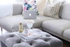 11 a grey upholstered ottoman doubles as a cool coffee table