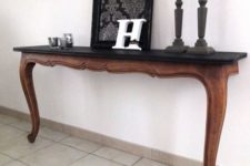 11 a super elegant console table cut in halves with a black wooden tabletop for a living room