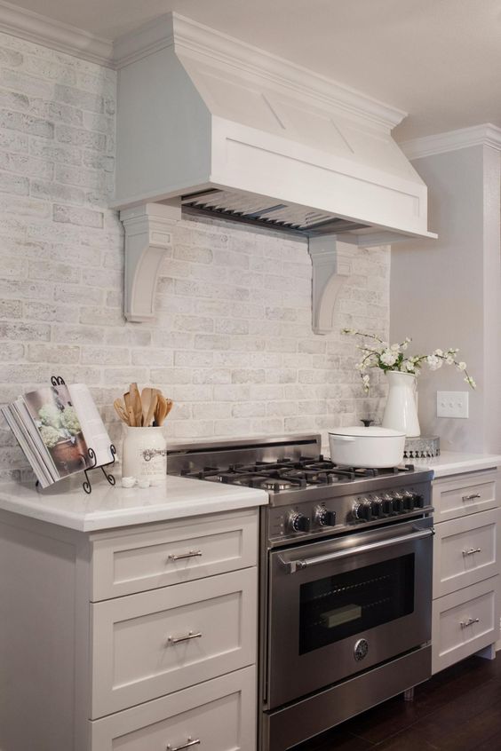 a whitewashed brick backsplash is a cool and chic idea to add texture to your kitchen