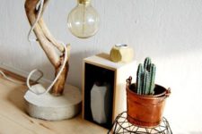 11 an eye-catchy table lamp of concrete, a curved tree branch and a large bulb is great for many decor styles