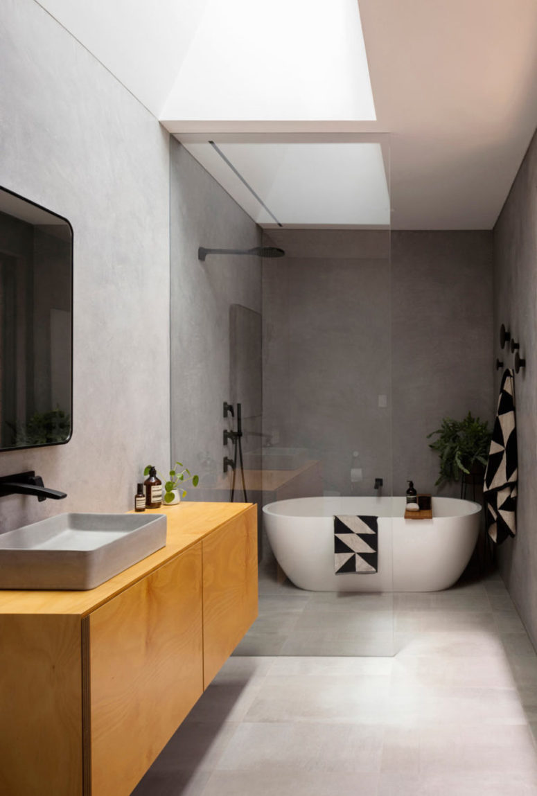 The master bathroom is done with concrete including a concrete sink and the same plywood as in the kitchen The master bathroom is done with concrete including a concrete sink and the same plywood as in the kitchen