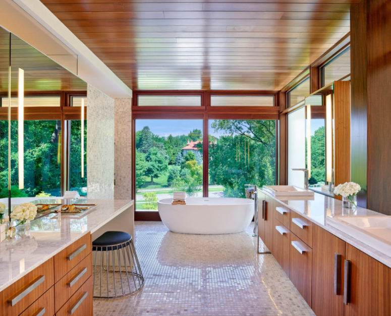 The bathroom also shows off some views and mother of pearl tiles that clad the whole space