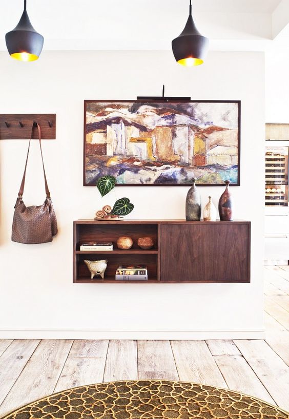 a floating console with an open and a closed compartment and a matching coat rack on the side