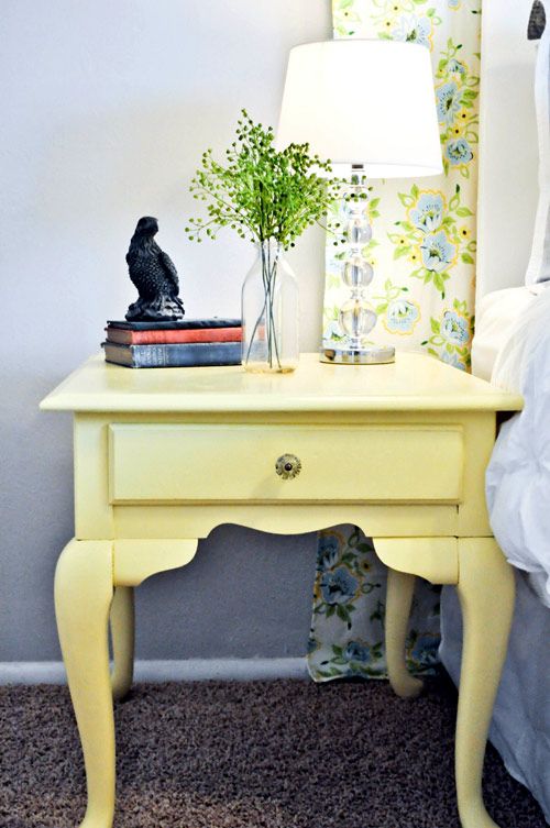 a light yellow nightstand DIYed of a vintage piece and yellow floral curtains