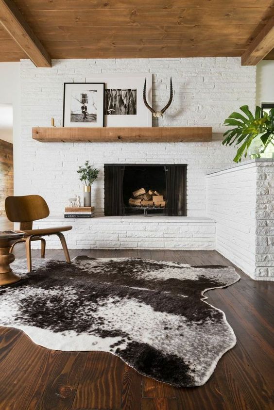 whitewashed brick walls and a fireplace clad this way for a mid-century modern living room