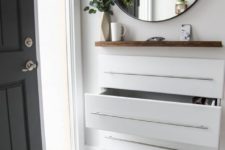 15 a modern entryway floating console with neutral pulls and a wooden shelf over it