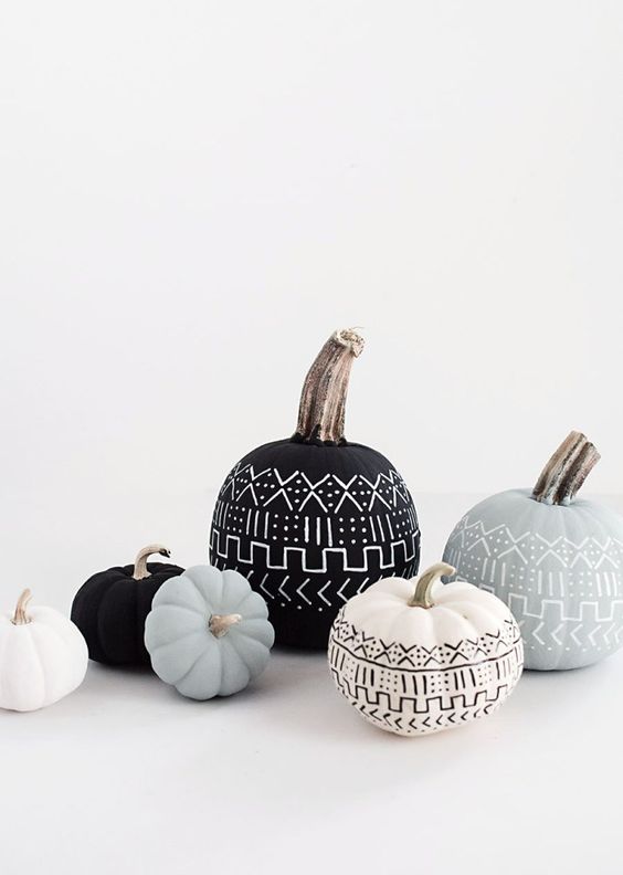an elegant black, white and grey pumpkin display with patterns done with a pen