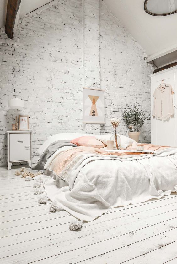 a whitewashed brick wall and a whitewashed wood floor make the space interesting playing with textures