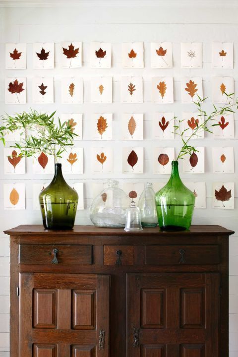 a whole wall take with little artworks - various fall leaves on paper, so vintage-like