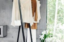 17 a large blackened metal clothes rack is very stable and can hold a lot of items, you may use it in your closet, too