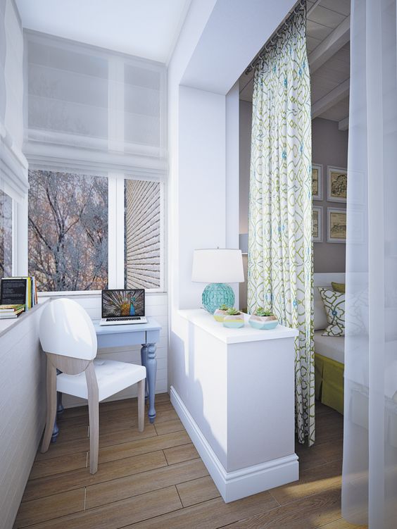 a workspace is blended in the bedroom yet separated from it with a half wall