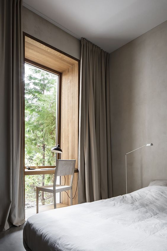 a conntemporary bedroom with a home office at the window that is blended seamlessly