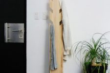 18 a modern coat rack made of a piece of wood with some hooks cut out is a simple DIY project