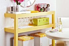 19 a colorful buffet made of a cut table painted bright yellow, with matchin ottomans