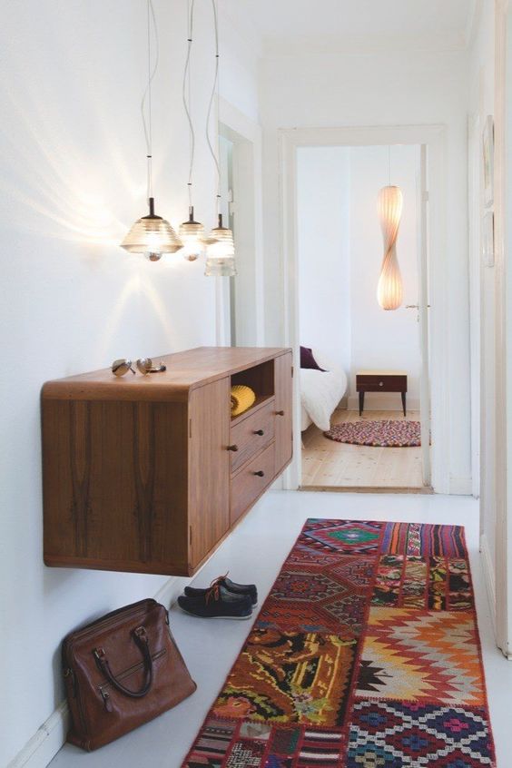 a simple and stylish mid-century modern plwyood floating console with colorful knobs for a boho feel