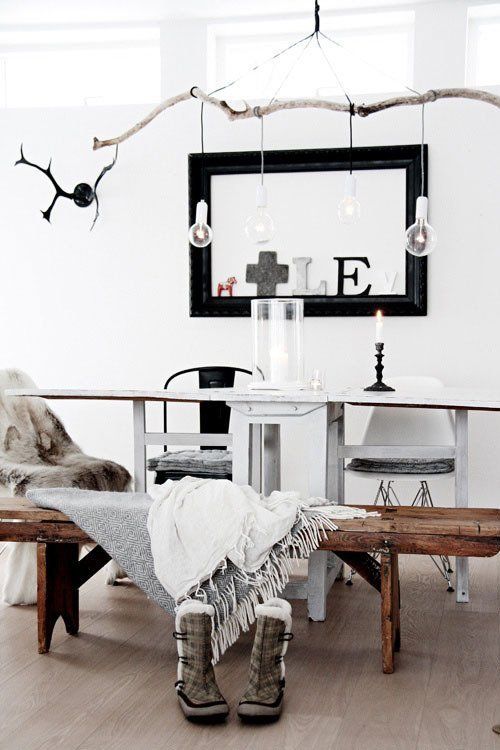 a large branch chandelier with lots of bulbs to highlight your Scandinavian dinner space