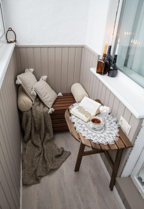 a small balcony can be furbished with a little bench and a half wooden table that matches