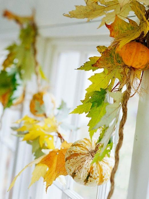 a gorgeous fall garland of fall leaves and small pumpkins plus twine for home decor