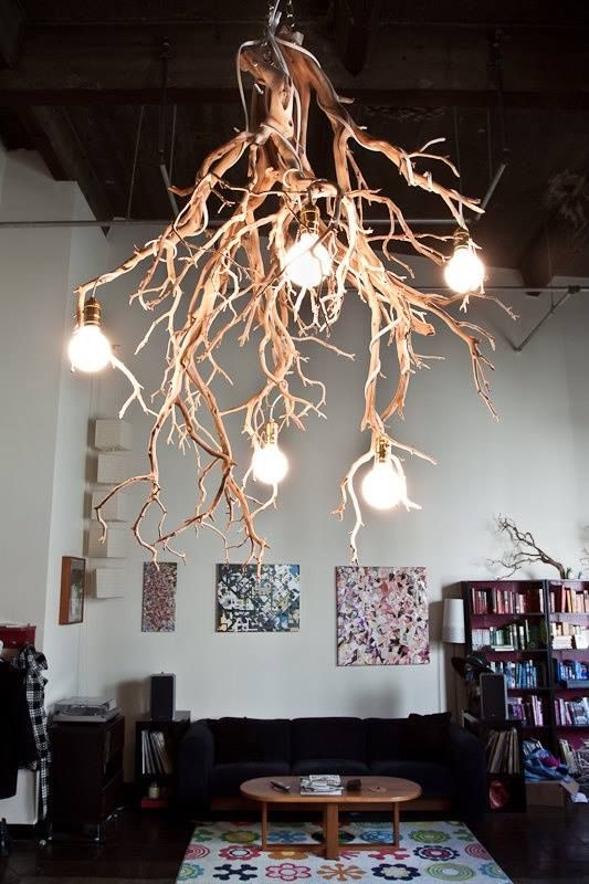 a statement chandelier of branches and industrial bulbs is sure to catch everybody's eyes with its contrasting look