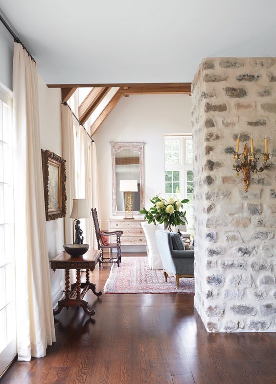 a whitewashed stone wall is ideal for an antique or vintage space, it's gorgeous backdrop