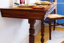 23 a wooden half table with casters is a great idea for small eat-in kitchen like this one