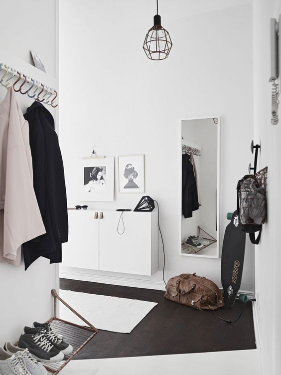 a white floating console table with leather pulls is ideal for a minimalist entryway