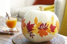 24 decorate a faux pumpkin with fall leaves using decoupage techniques and display it for the fall and Thanksgiving