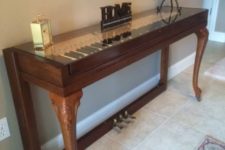 25 Wurlitzer piano with beautiful legs repurposed into a creative and chic console for an entryway