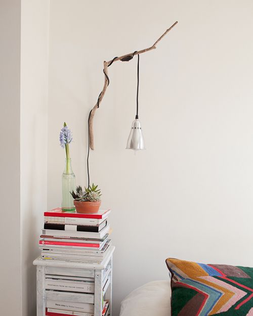 make a cool sconce for your bedroom using a usual branch and a pendant lamp with a glass shade