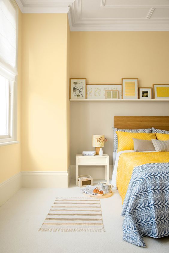 pastel yellow walls and bright yellow bedding and pillows create a very warm ambience