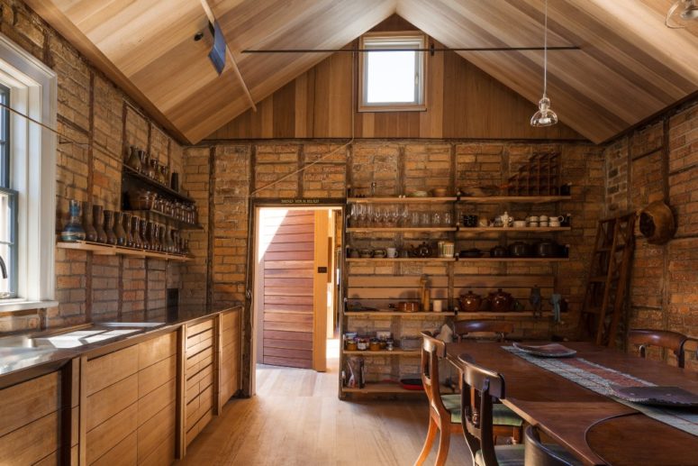 The kitchen feels like totally original, with stone walls and wooden furniture, with open shelving