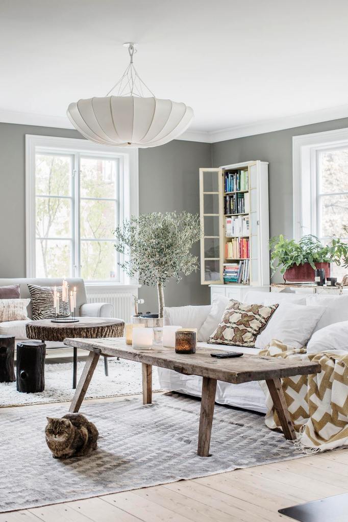 The living room is truly Scaninavian, with grey walls and light-colored wooden floors that were installed in 1898 and then restored