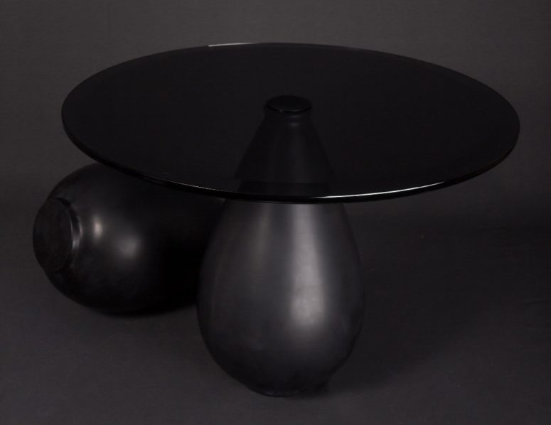 The shape of the table is unique, it's a marble base shaped as a tear and a round glass top