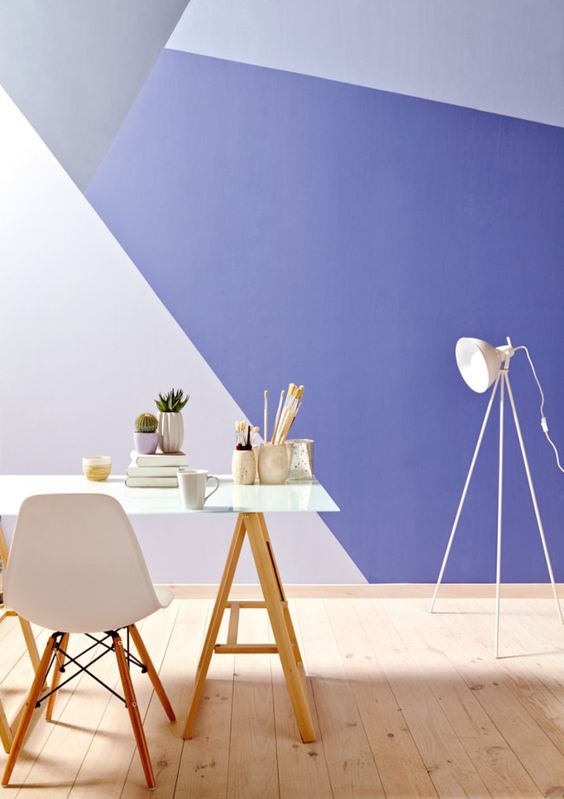 a bright geometric color block wall in blush, grey and purple for a bold home office look