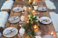 02 a natural tablescape with a greenery runner, candles in lanterns and napkins, some white blooms for a festive feel