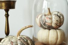 04 a cloche with a white and marbleized pumpkin is a fast and cute centerpiece you can make last minute