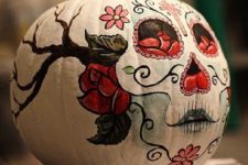a pumpkin with a painted sugar skull is a nod at the Mexican holiday and a great boho idea for Halloween