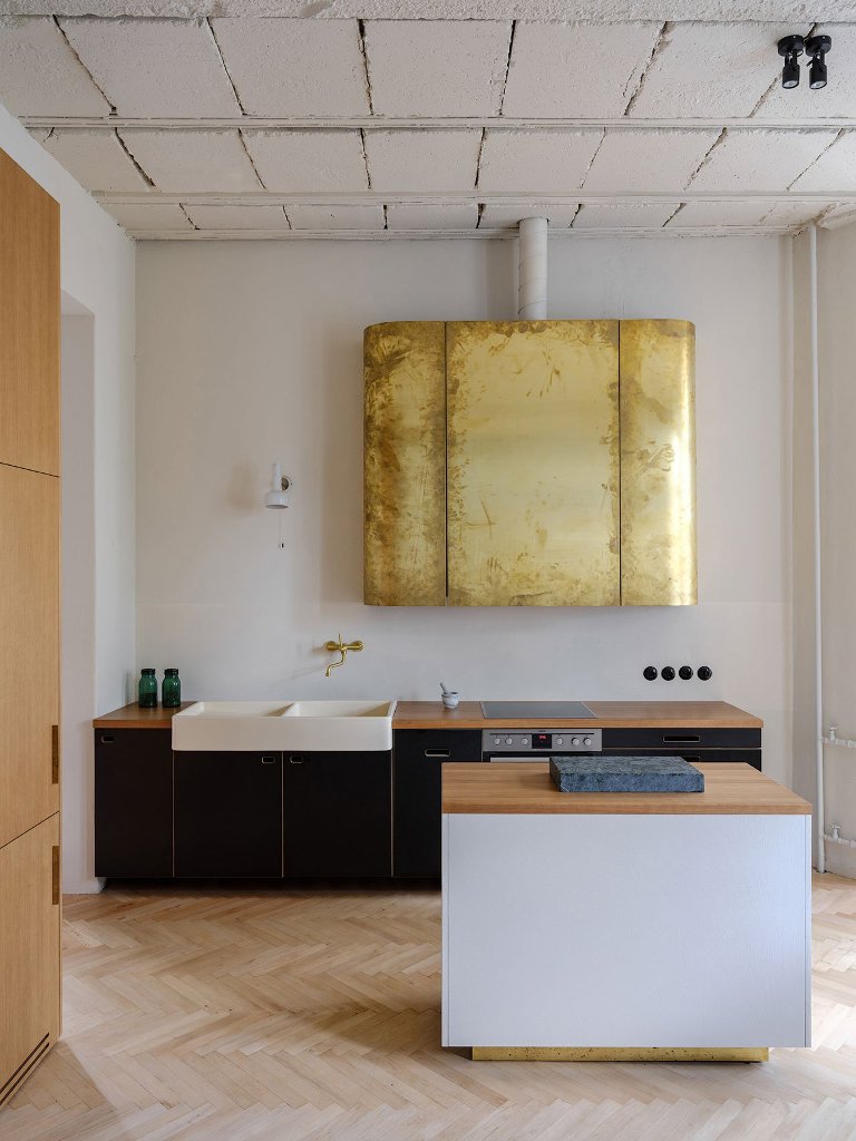 The kitchen is done with dark and light colored plywood cabinets and look at that gold leaf hood isn't it a statement The kitchen is done with dark and light-colored plywood cabinets and look at that gold leaf hood -isn't it a statement